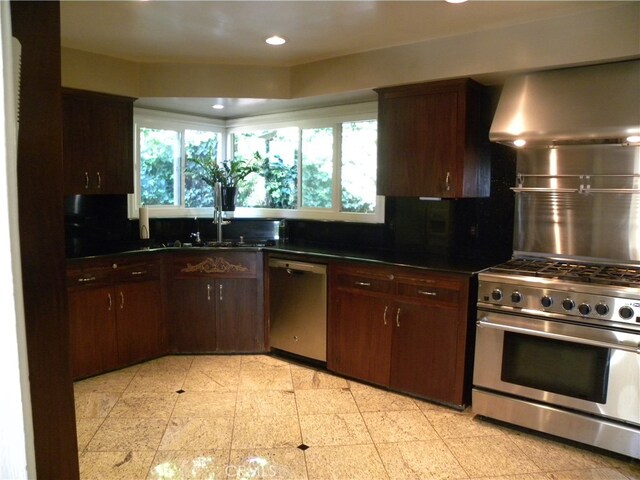 kitchen featuring extractor fan, appliances with stainless steel finishes, dark brown cabinetry, and tasteful backsplash