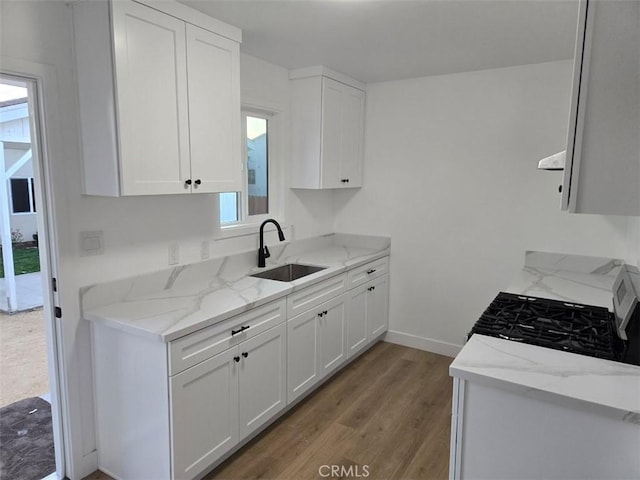 kitchen featuring white cabinetry, plenty of natural light, and sink