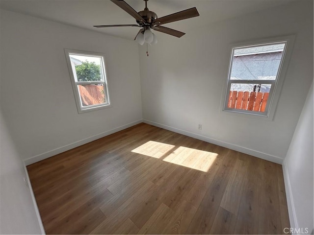 spare room with ceiling fan and hardwood / wood-style flooring