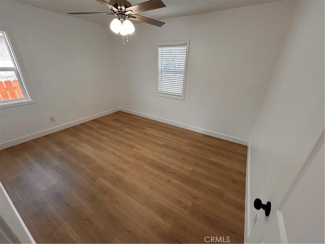 spare room with hardwood / wood-style floors, ceiling fan, and a wealth of natural light