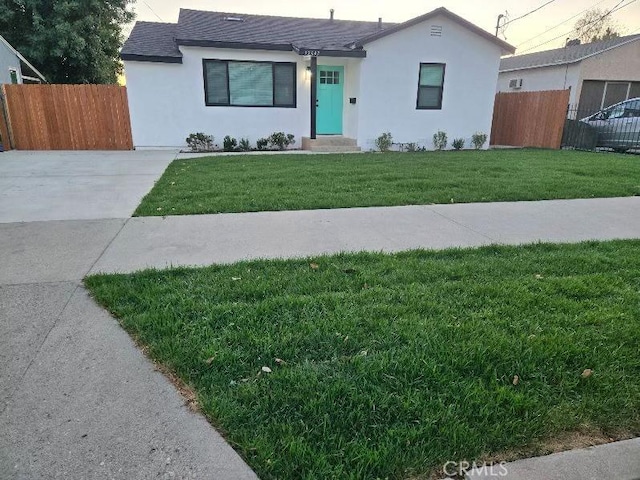 ranch-style home featuring a front yard