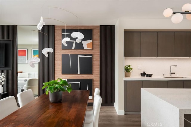 dining space featuring dark hardwood / wood-style flooring and sink