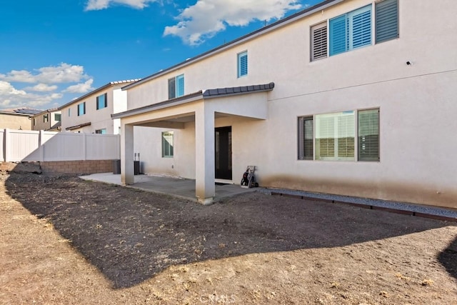 rear view of property featuring a patio area