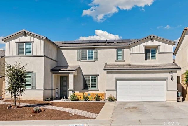 view of front of home with a garage and solar panels