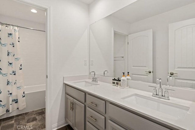 bathroom featuring vanity and shower / bathtub combination with curtain