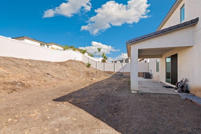 view of yard featuring cooling unit and a patio