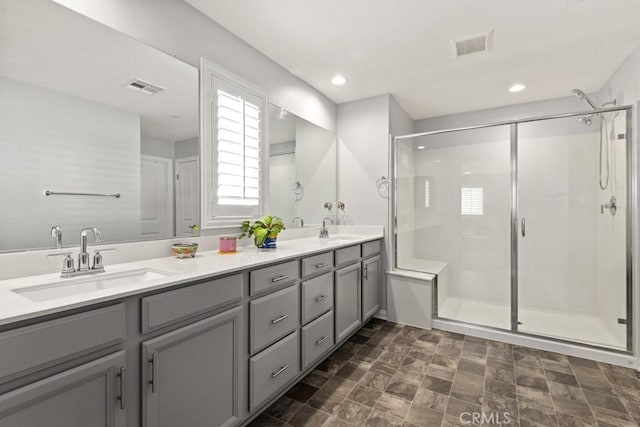 bathroom with vanity and a shower with shower door