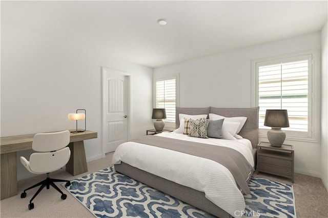 bedroom featuring multiple windows and light carpet