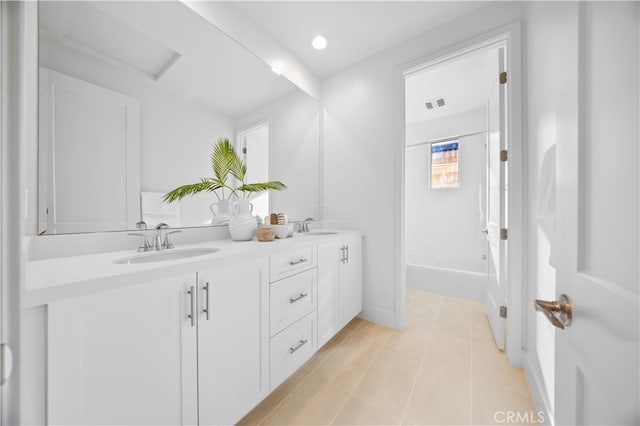 bathroom featuring tile patterned flooring and vanity