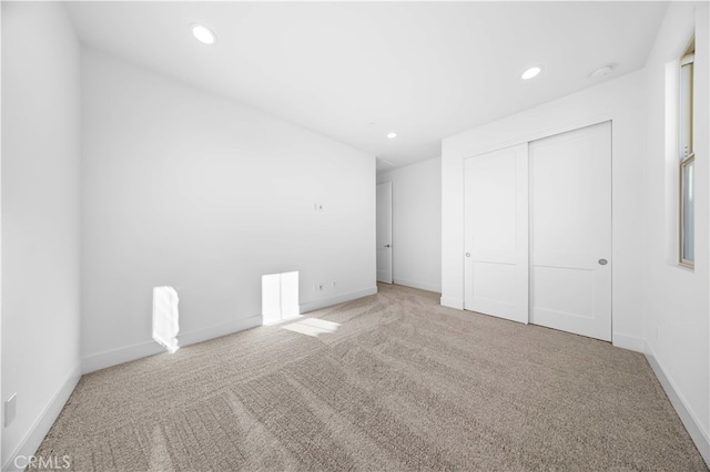 unfurnished bedroom featuring carpet floors and a closet