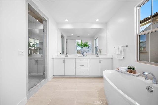 bathroom with tile patterned flooring, vanity, and independent shower and bath