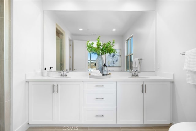 bathroom featuring tile patterned flooring and vanity