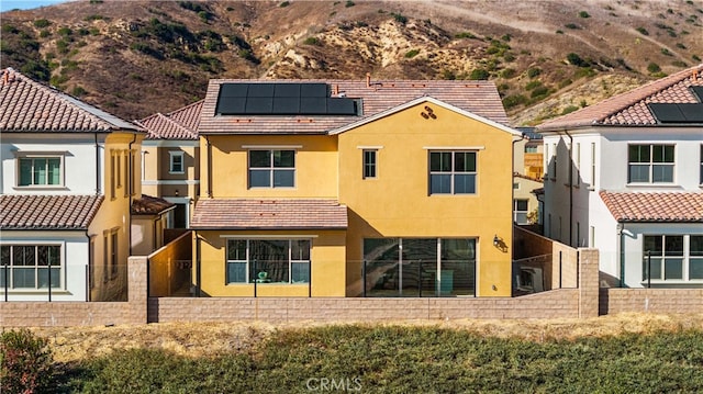 back of property with solar panels