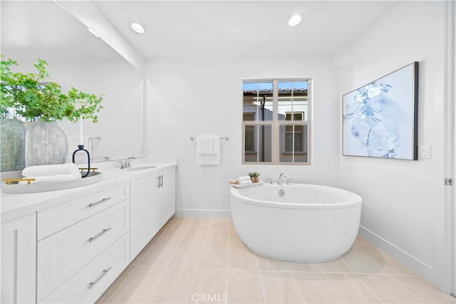 bathroom featuring vanity, tile patterned floors, and a tub