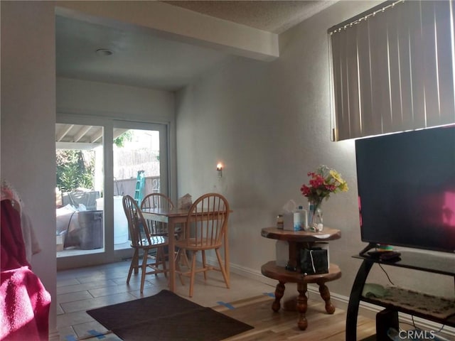 dining space featuring baseboards and wood finished floors