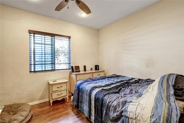 bedroom featuring ceiling fan and dark wood-type flooring