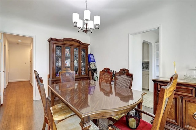 dining room with a chandelier and light hardwood / wood-style floors