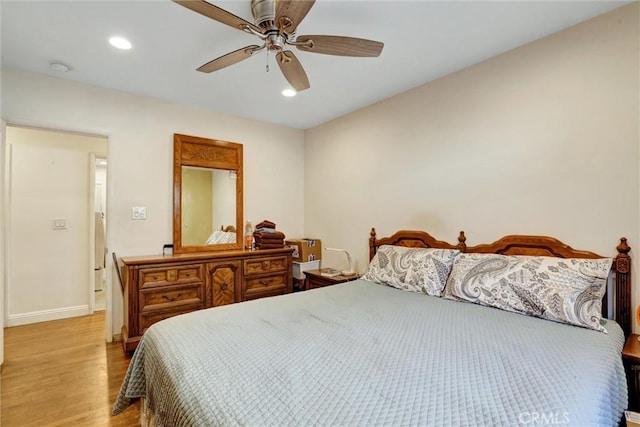 bedroom with ceiling fan and light hardwood / wood-style flooring