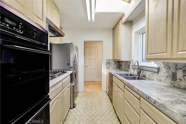 kitchen with light brown cabinetry, oven, stainless steel dishwasher, and sink