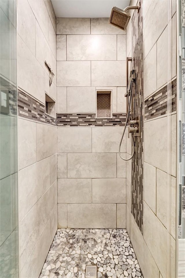 bathroom with tiled shower