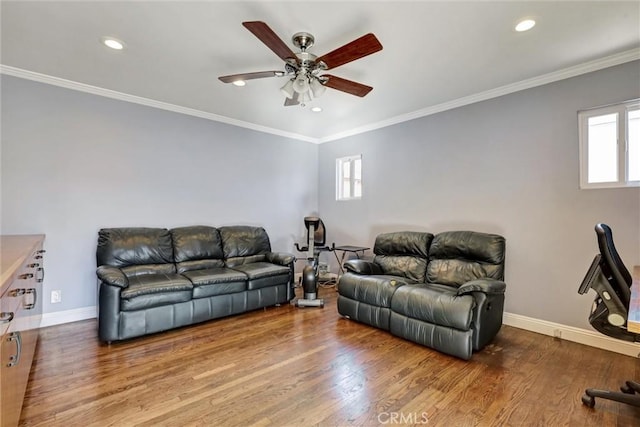 living room featuring ceiling fan, wood-type flooring, and ornamental molding