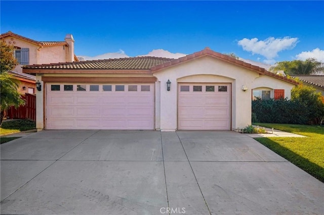 mediterranean / spanish home with a garage