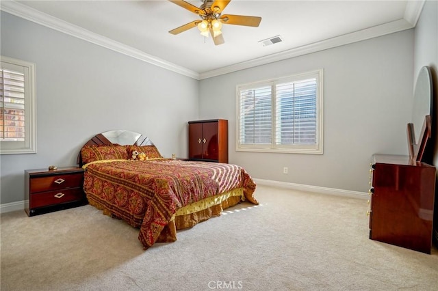 carpeted bedroom with ceiling fan and crown molding