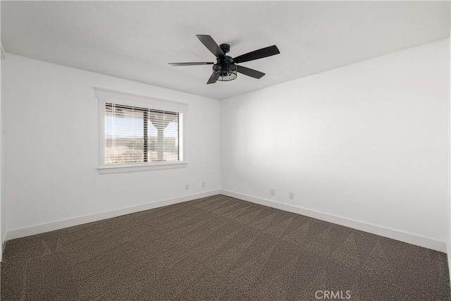 spare room featuring carpet and ceiling fan