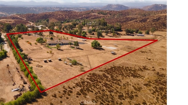 drone / aerial view featuring a mountain view and a rural view