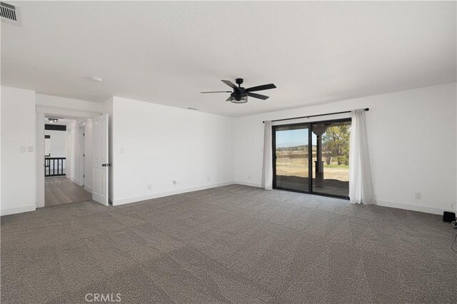 spare room featuring ceiling fan and carpet floors