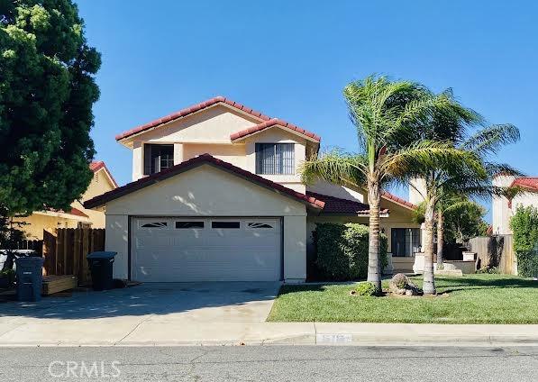 mediterranean / spanish home with a garage and a front yard