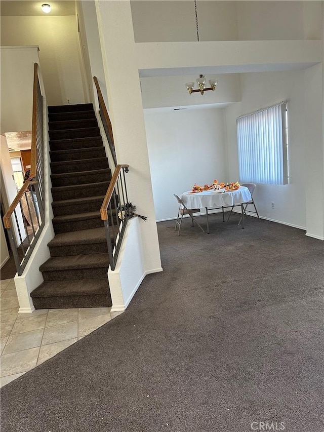 stairs featuring carpet and a notable chandelier