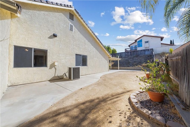 view of side of home featuring central AC unit and a patio