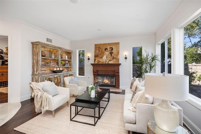 living room with wood-type flooring and ornamental molding