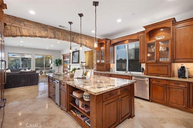 kitchen with dishwasher, a center island, sink, light stone counters, and decorative light fixtures