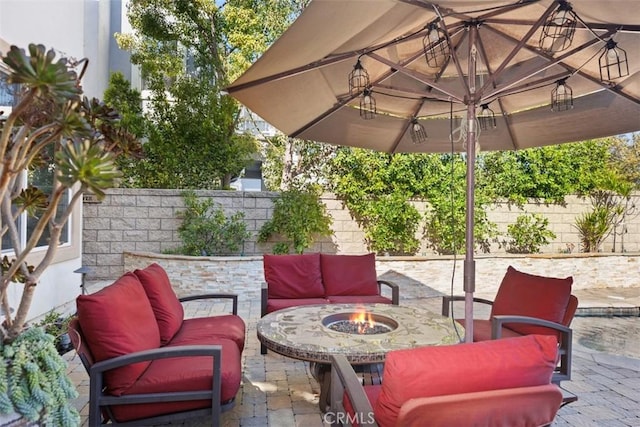 view of patio / terrace featuring an outdoor living space with a fire pit