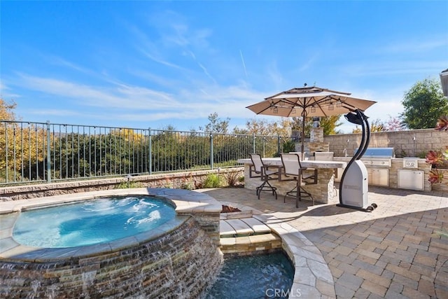 view of pool with area for grilling, an in ground hot tub, a patio area, and a bar