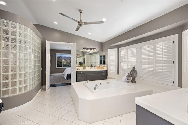 bathroom featuring tile patterned flooring, vanity, vaulted ceiling, and ceiling fan