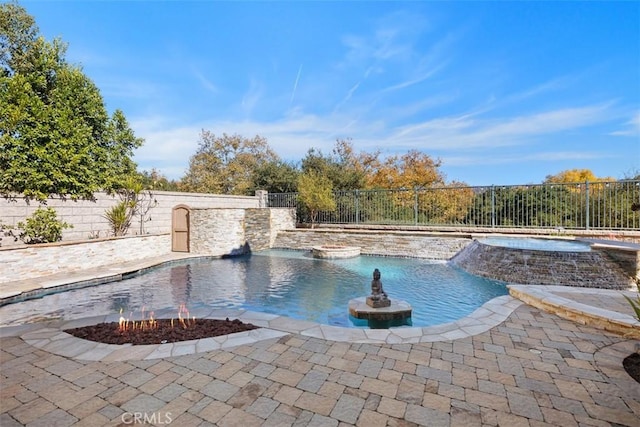 view of pool with pool water feature, an in ground hot tub, and a patio