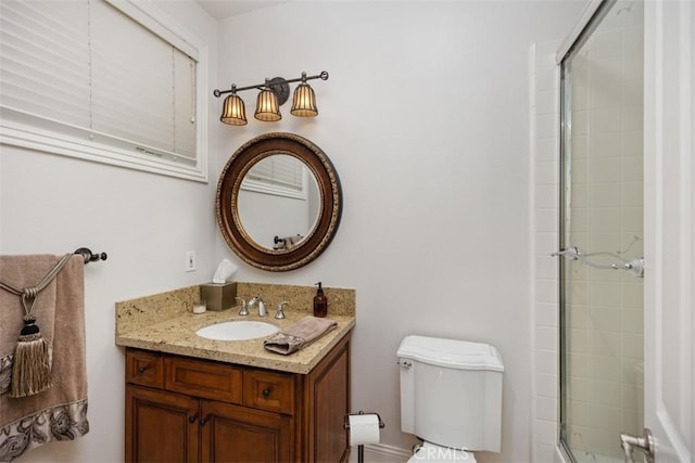 bathroom featuring toilet, vanity, and walk in shower