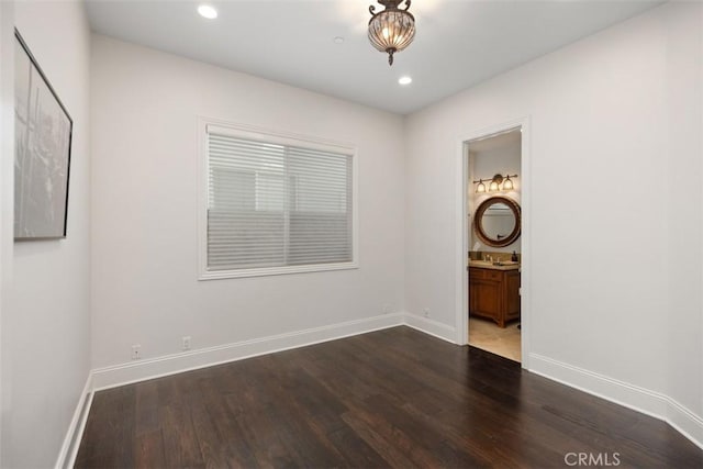 unfurnished room with dark hardwood / wood-style flooring