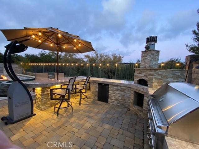 view of patio / terrace featuring area for grilling, exterior bar, and grilling area