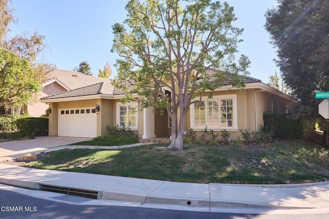 view of front facade with a front yard and a garage