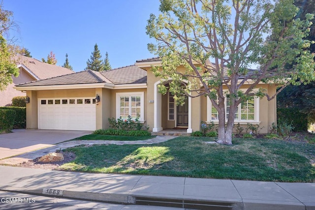 view of front facade featuring a garage and a front lawn