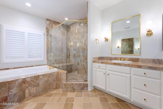 bathroom with tile patterned floors, vanity, and shower with separate bathtub