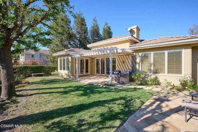 rear view of property featuring a pergola, a patio area, and a yard