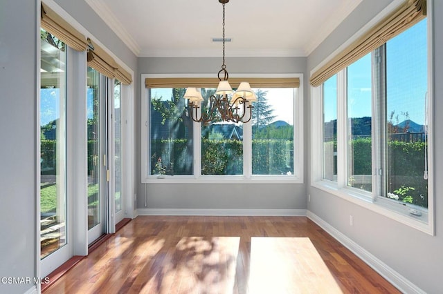 unfurnished sunroom with a healthy amount of sunlight and a notable chandelier