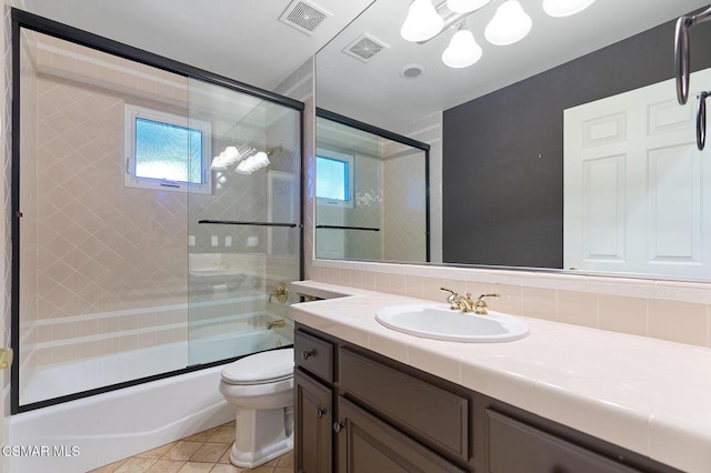 full bathroom with tasteful backsplash, vanity, enclosed tub / shower combo, tile patterned flooring, and toilet