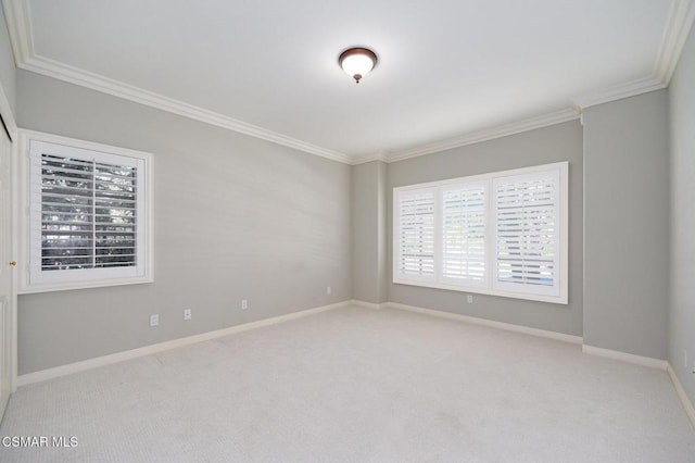 carpeted spare room featuring ornamental molding