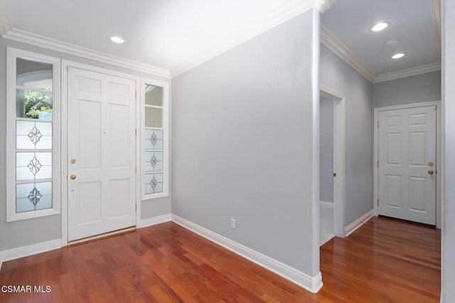 foyer entrance with crown molding and dark hardwood / wood-style flooring